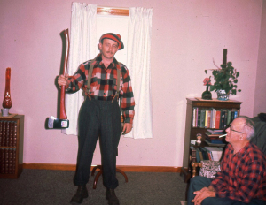 Dad as a lumberjack, with Grandpa Powers watching.